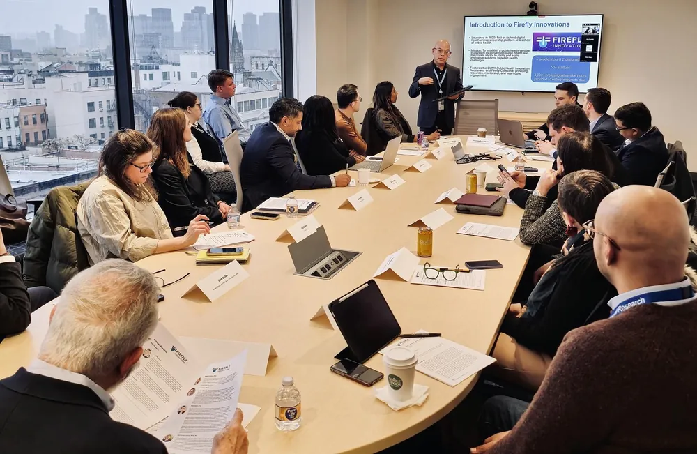Firefly Innovations briefing — presenter introducing the platform to a boardroom audience at CUNY SPH